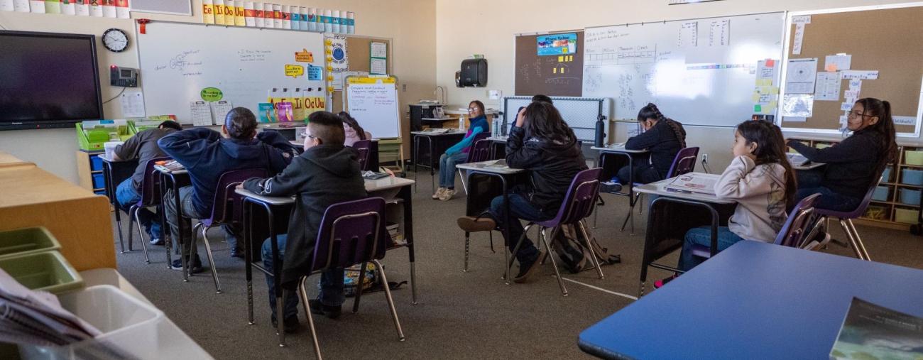 Classroom with students sitting at their desks during a lesson.